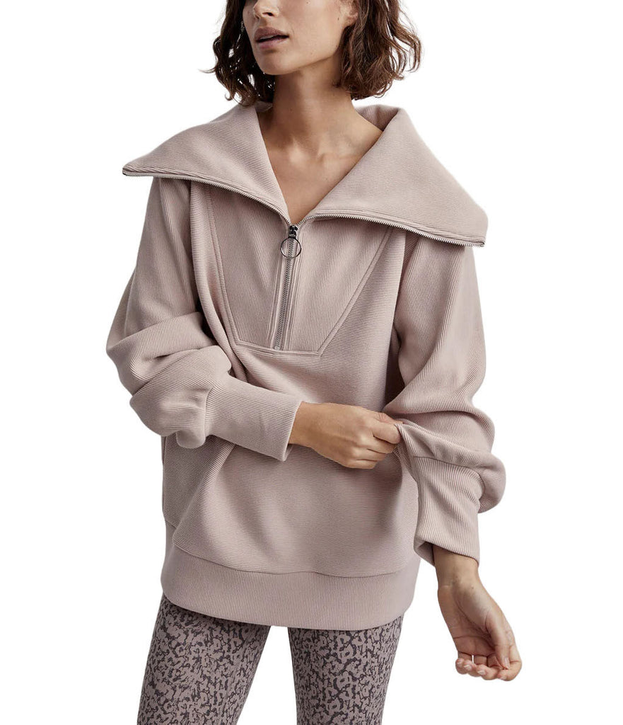 Varley Vine Half Zip Mushroom. The Vine effortlessly blends function, elegance, and style in a distinctive oversized design, featuring a half zip for an oversized fit with long, exaggerated sleeves for a voluminous silhouette.