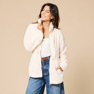 Women’s plush zip-up jacket with a stand collar, adjustable drawstring waist, front pockets, and curved hem.