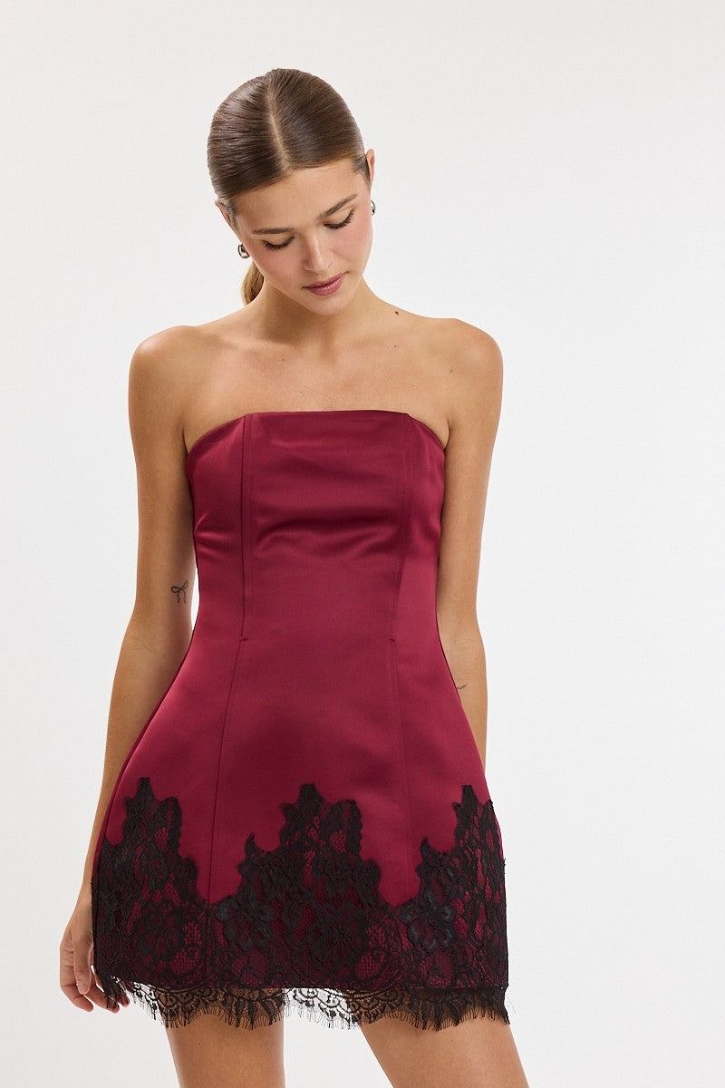 Strapless satin mini dress with a fitted silhouette and lace-trim hem, designed for parties, weddings, and special occasions.