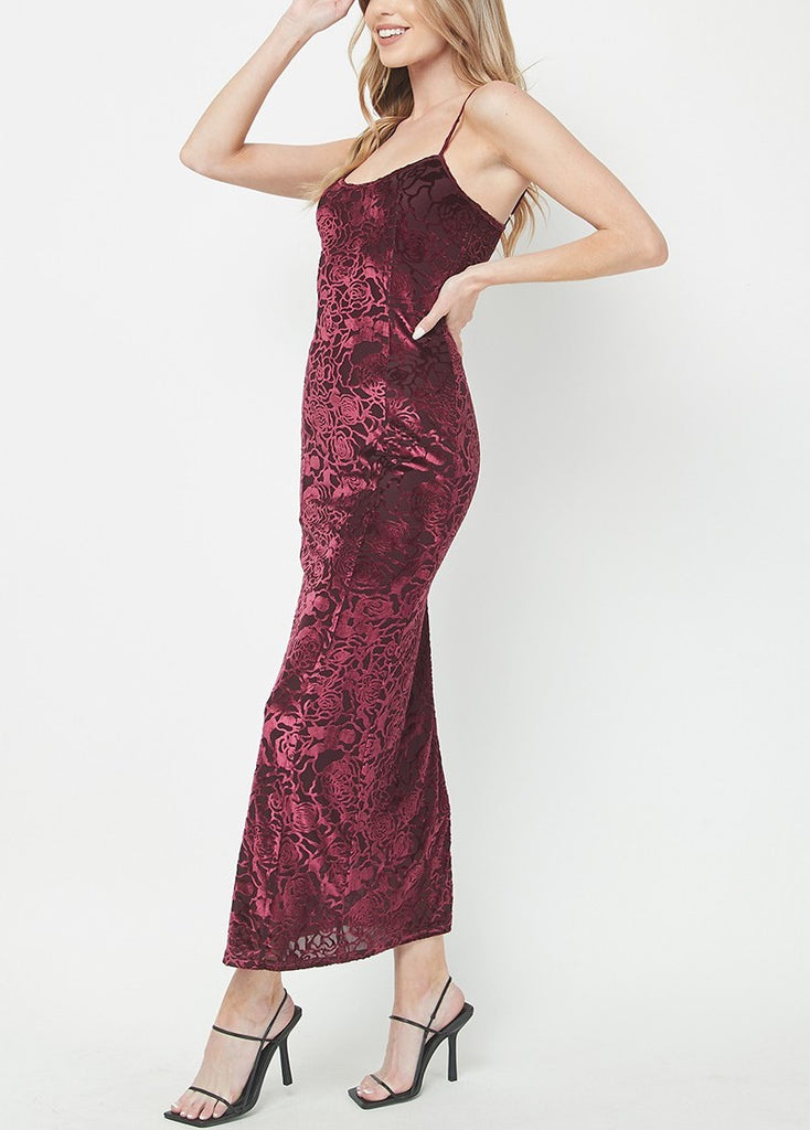 Burnout Velvet Maxi Dress Wine. This elegant maxi dress features a burnout velvet design and adjustable straps for the perfect fit, sure to make you stand out at your next special occasion.