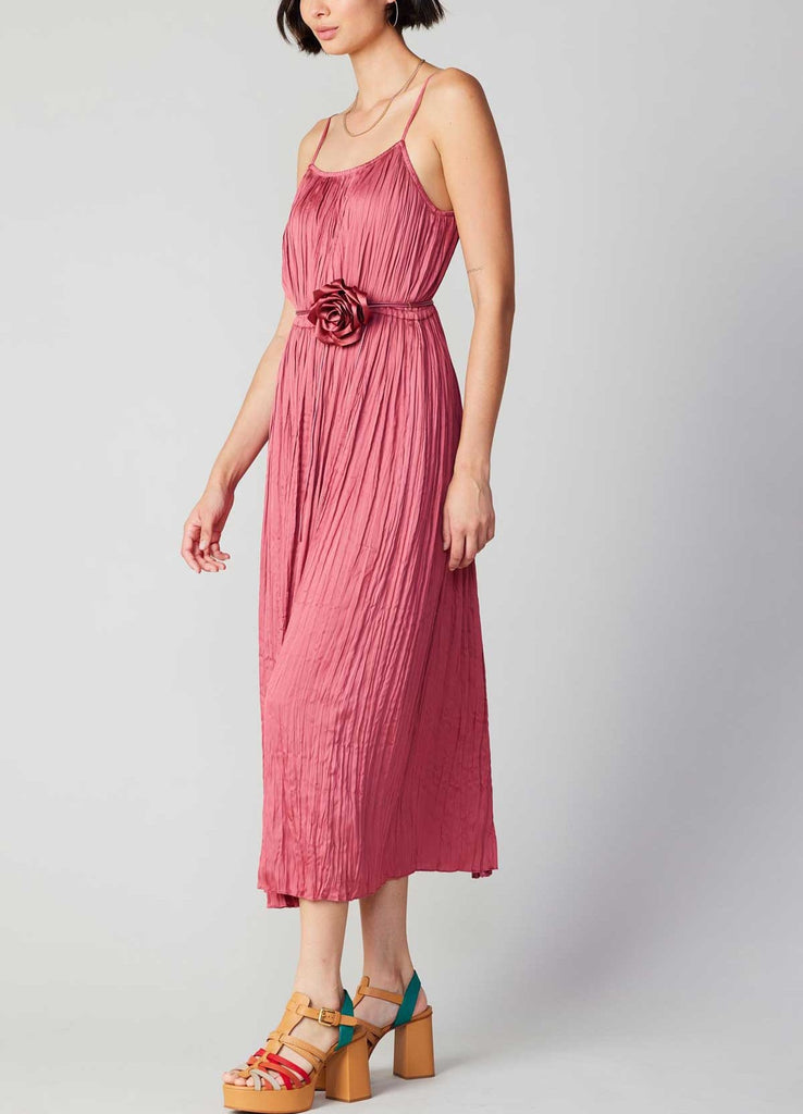 Current Air Cami Flower Dress Rouge Blush. This cami dress couldn't be more effortless. The silhouette itself is simple, but the details make it shine. Suspended by slim straps, it has gently crinkled gathers and cinches in at the waist before flowing to an ankle-sweeping hem. A tie belt adorned with a matching rosette adds the perfect finish.