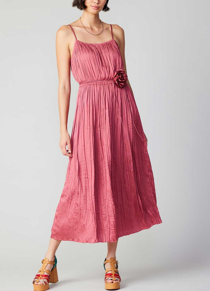 Current Air Cami Flower Dress Rouge Blush. This cami dress couldn't be more effortless. The silhouette itself is simple, but the details make it shine. Suspended by slim straps, it has gently crinkled gathers and cinches in at the waist before flowing to an ankle-sweeping hem. A tie belt adorned with a matching rosette adds the perfect finish.