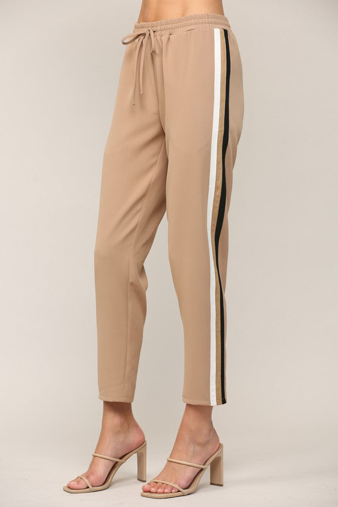 Fate Stripe Detail Jogger Tan. These joggers feature a contrast side twill tape trim design with a drawstring waistband, perfect for a sporty throwback look.