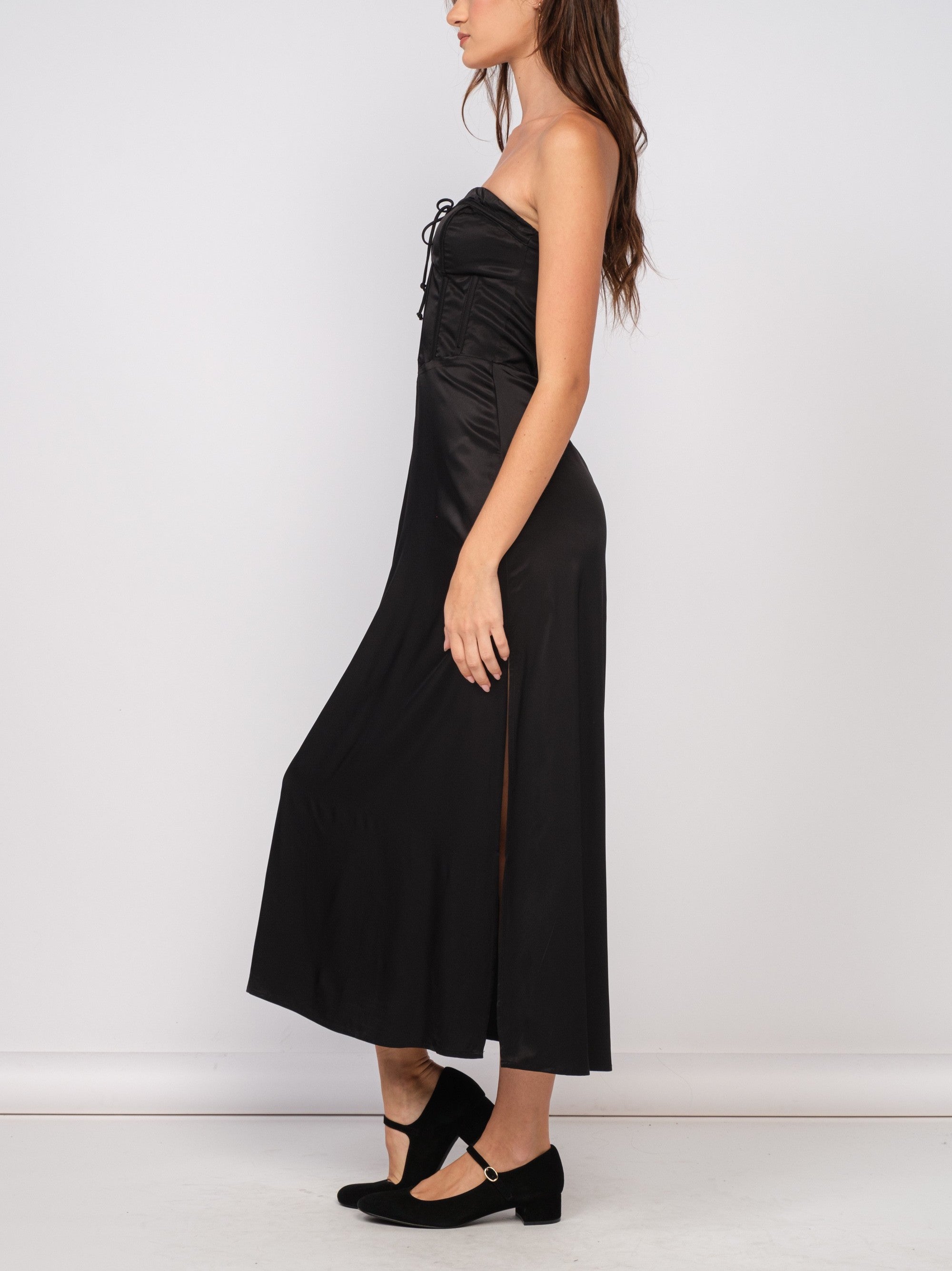 Ava Corset Satin Maxi Dress Black. This strapless satin maxi dress features a corset style bust and a zip back closure, perfect for looking chic at any special occasion.