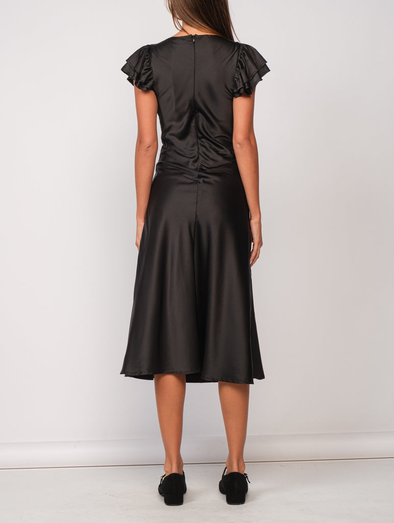 Piper Lace Trim Satin Dress Black. This black maxi dress features ruffled sleeves and lace trim for an elegant look perfect for a holiday party or special night out.