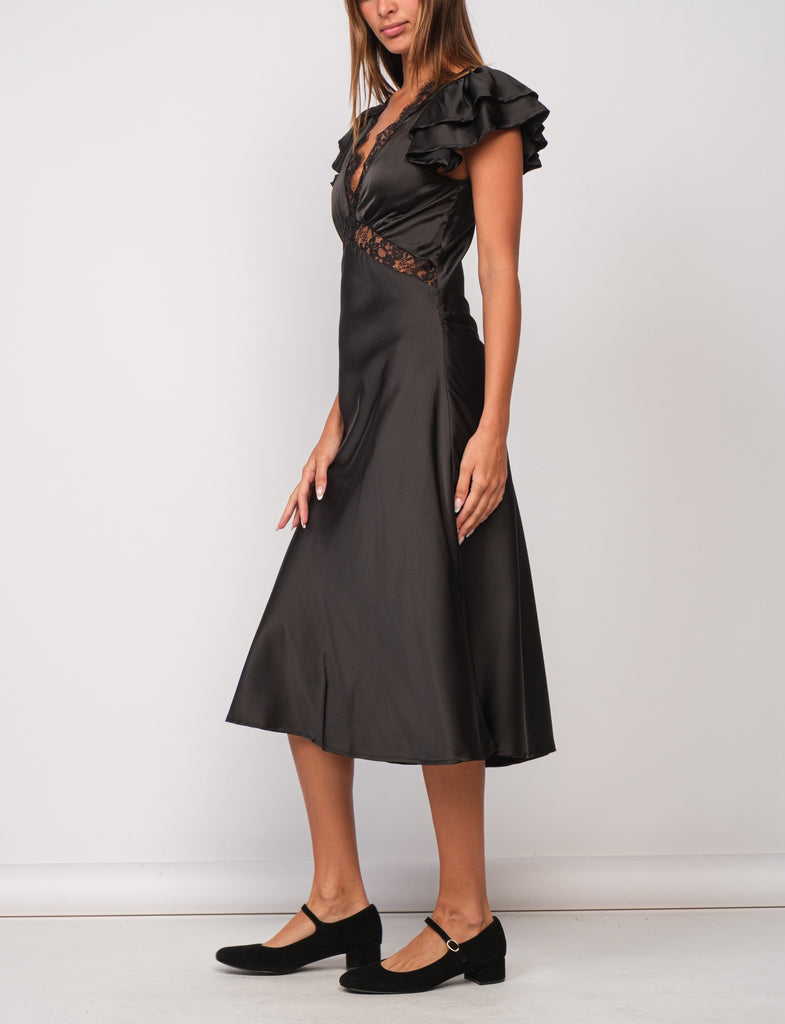 Piper Lace Trim Satin Dress Black. This black maxi dress features ruffled sleeves and lace trim for an elegant look perfect for a holiday party or special night out.