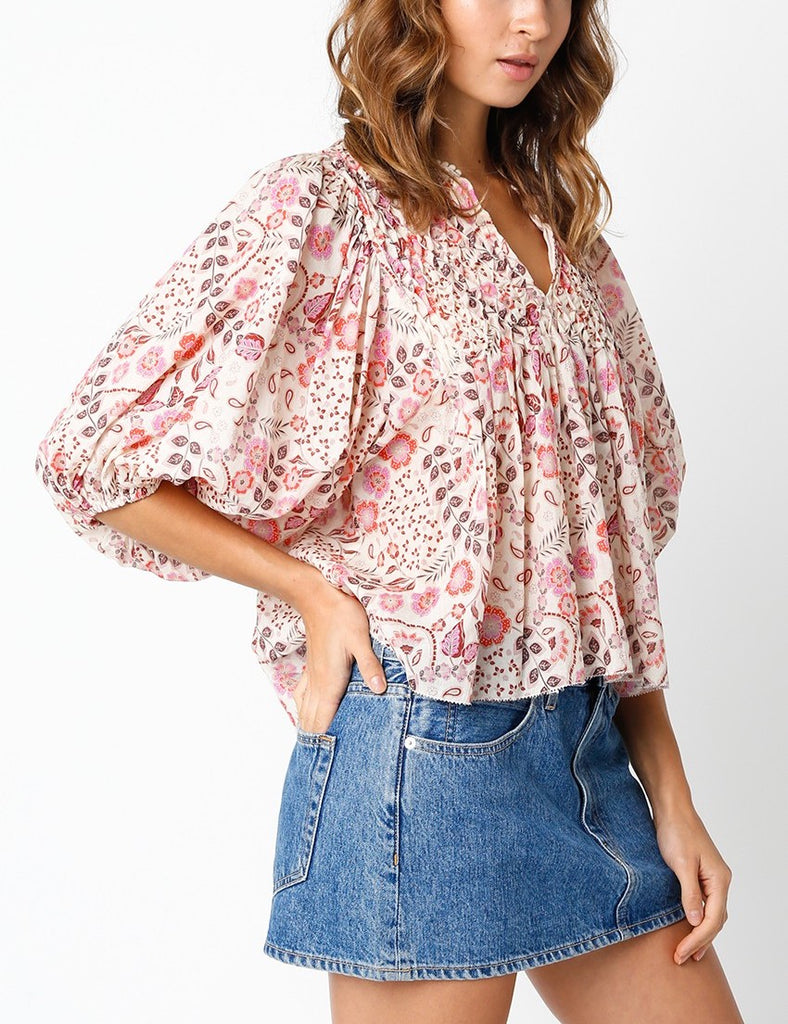 Jennifer Floral Split Neck Top Floral Pattern Pink. This split neck top features a floral pattern with an oversized sleeve and cropped body, the perfect top for throwing on with your fav jeans or pants.