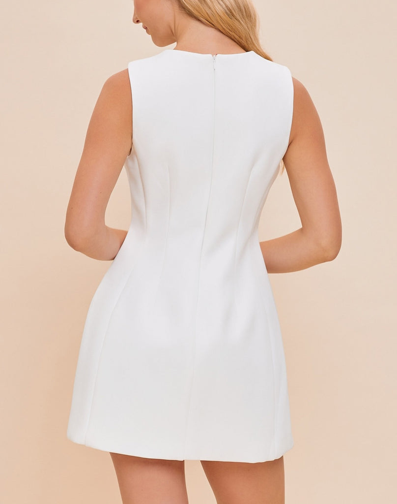 Tamara High Neck Mini Dress White. This adorable mini dress features a high neck and a-line fit with a zip close back, so easy to dress up with heels or down with sneakers and a denim jacket.