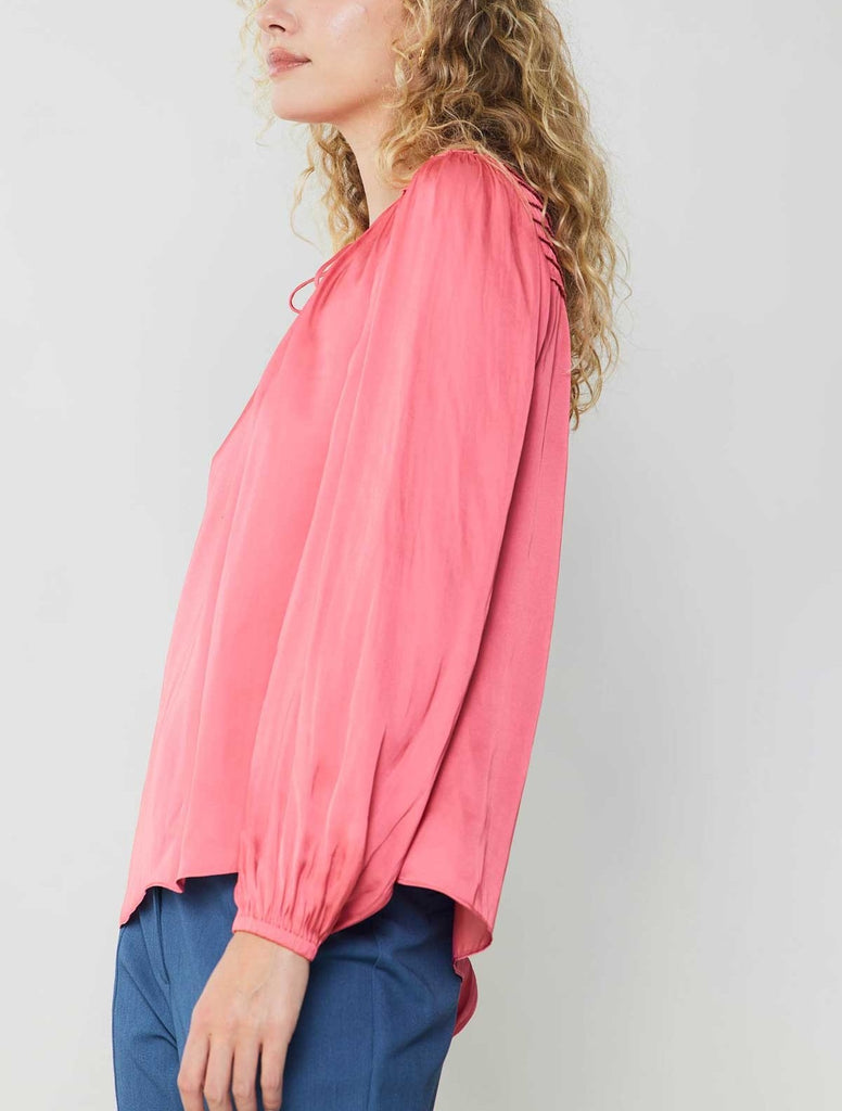 Current Air Tie Smock Blouse Brink Pink. A lustrous split-neck blouse brings polished ease to any outfit. This popover top has a fluid fit that's framed by puffed sleeves and features a delicate shirred yoke. That little tie detail at the neckline delivers the sweetest finish.