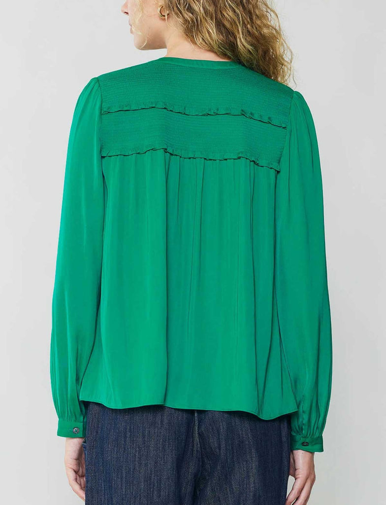 Current Air Smocked Yoke Tie Blouse Green. This long sleeve split neck top features a self-tie and ruffle detail, the vibrant green is a perfect pop of color to add to your wardrobe.