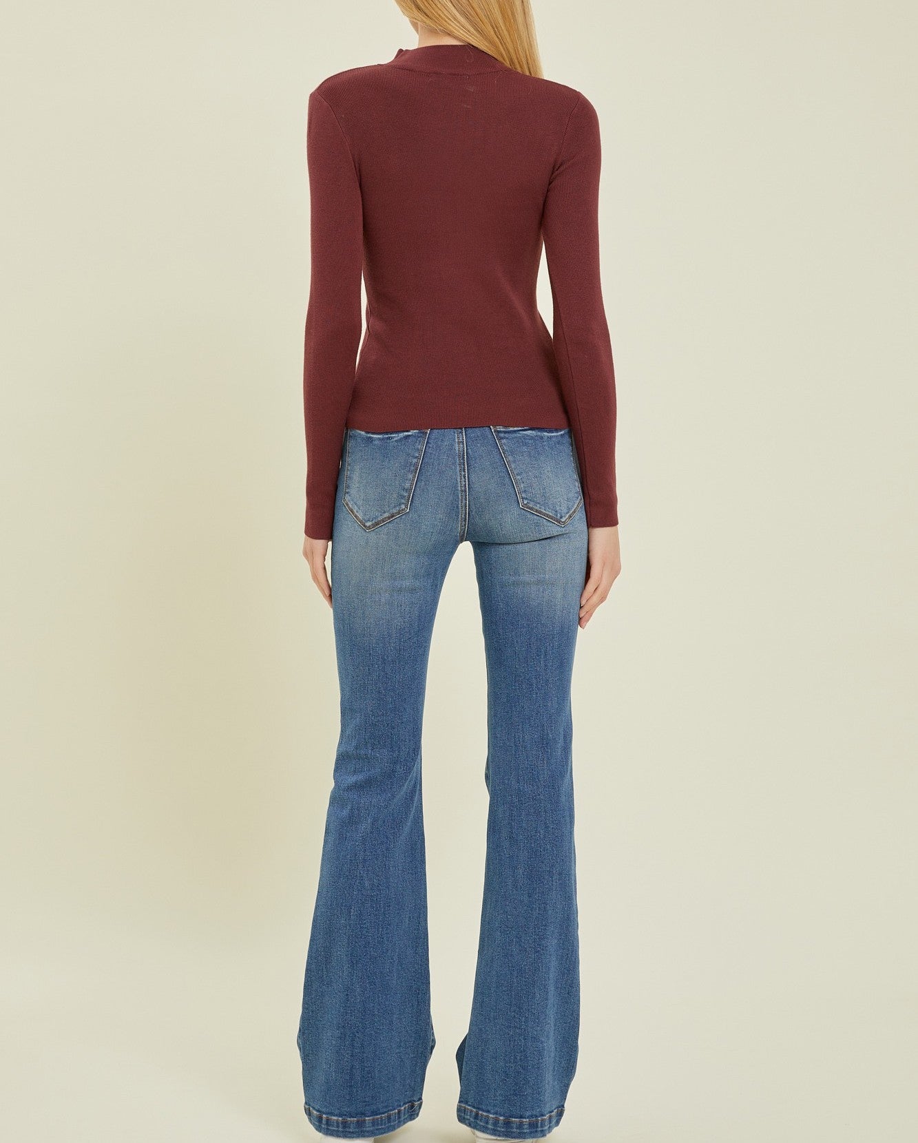 Moonbeam Long Sleeve Sweater Wine. This ribbed long sleeve sweater features a mock neckline and fitted design making it the perfect layering piece for everyday.