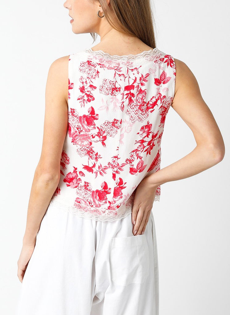 Therese Tie Front Print Top Cream Red. This sleeveless tie front top features a square neckline with lace trim and floral design, wear it alone for a more bare look or layer it over a tank with jeans.