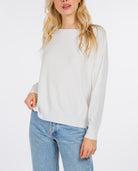 Madeline Boatneck Pullover Off White. This boatneck pullover sweater features ribbing at the hem and cuffs and a fitted design perfect for throwing on with your favorite jeans for a cute easy look.
