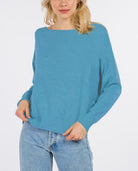Madeline Boatneck Pullover Azure. This boatneck pullover sweater features ribbing at the hem and cuffs and a fitted design perfect for throwing on with your favorite jeans for a cute easy look.