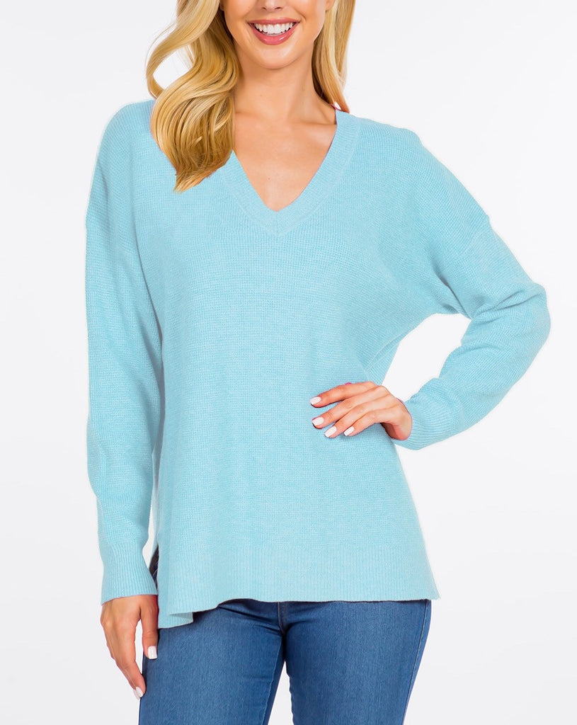 Brielle Waffle Knit Pullover Heather Rain. This waffle knit pullover sweater features a v-neckline and slightly oversized fit perfect for throwing on with leggings or jeans for a quick easy outfit.