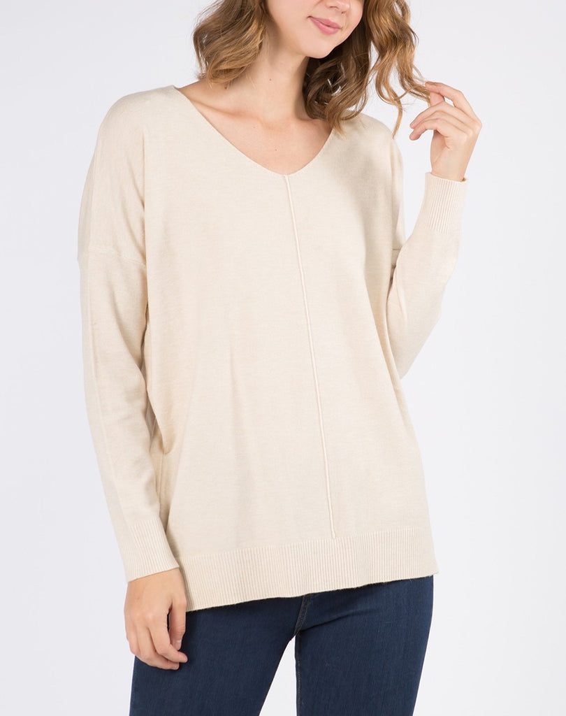 Nina Front Seam V-Neck Sweater Heather Oatmeal. This front seem sweater features a v-neckline and is a closet staple for year round wear, so soft and cozy you'll want to throw this on every morning.