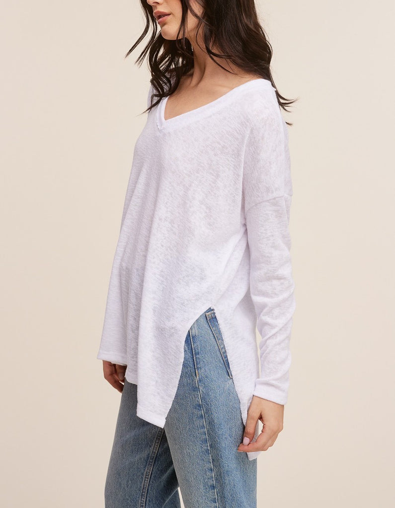 Raquel V-Neck Long Sleeve Top White. This ultra lightweight long sleeve top features a v-neckline and side slit detail, the oversized fit make it perfect for throwing on with leggings for an easy outfit.