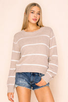 Lightweight striped knit sweater with relaxed fit and slightly cropped length styled with denim shorts