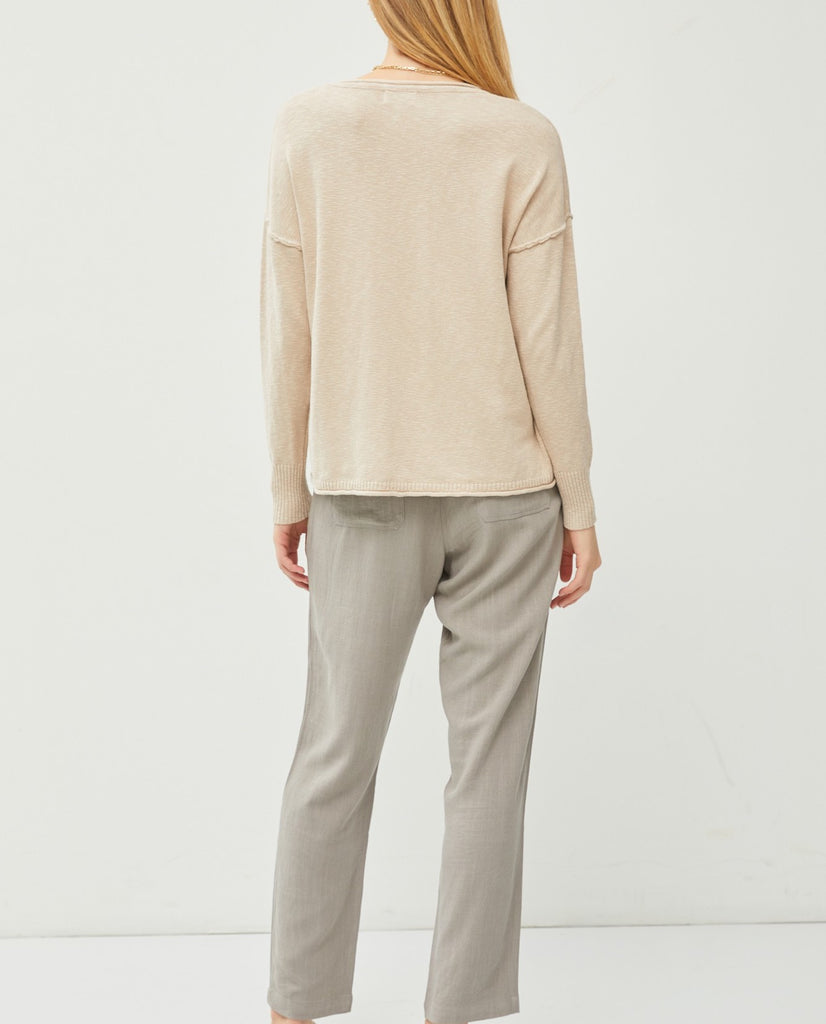 Palmer Drop Shoulder Top Light Taupe. This lightweight drop shoulder top features a relaxed fit and exposed seam details, the perfect everyday piece to wear with jeans or pants when you're on the go.