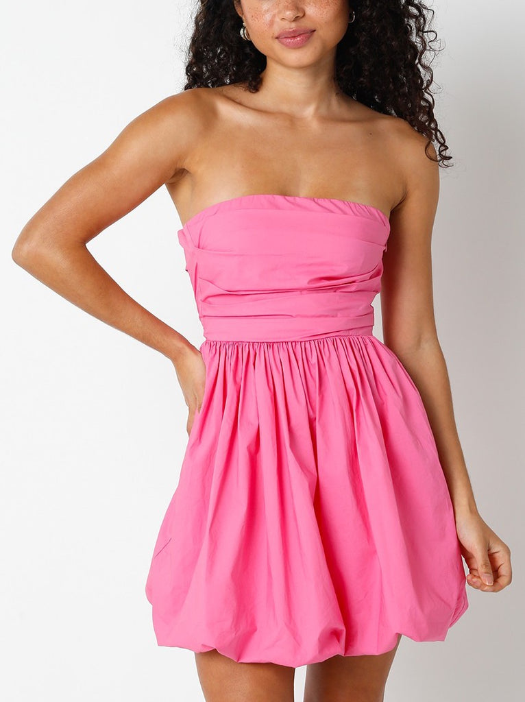 Elliana Strapless Tie Back Dress Pink. This strapless mini dress features a fitted bodice and billowed bottom with a gorgeous tie back, the cutest dress for any special occasion.