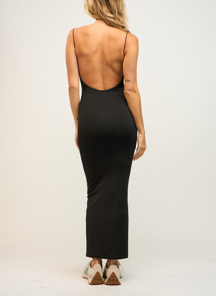 Annalise Bodycon Maxi Dress Black. This fitted maxi dress features an open back with skinny straps, perfect for dressing up with heels or down with sneakers and a denim jacket.