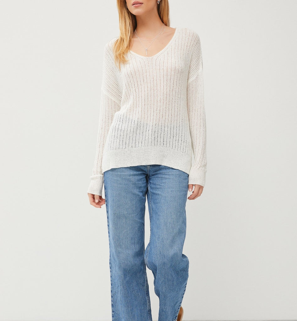 Teagan Sheer Knit Top White. This lightweight knit top features a wide v-neckline and long sleeves, perfect for layering over your fav tank and pairing with jeans.