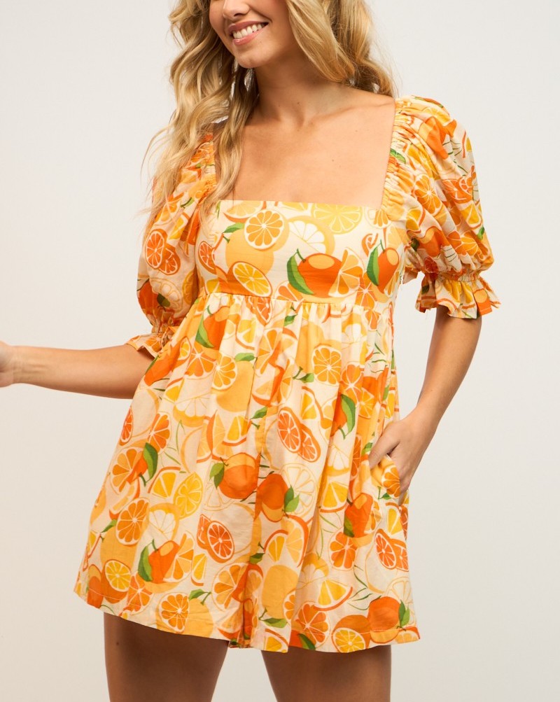 Katy Orange Puff Sleeve Romper Orange Print. This adorable puff sleeve romper features a square neck and orange print design for a cute and bight look that is sure to add some color to your day.