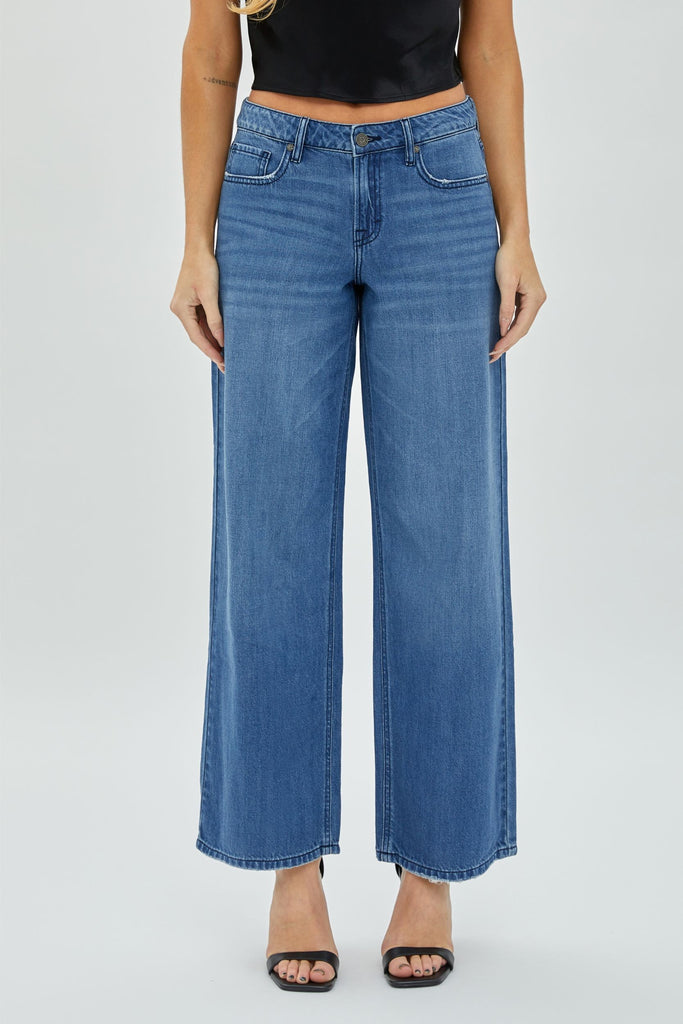 Hidden Nori Clean Wide Leg Jean Medium Dark. These wide leg jeans feature a clean design in the perfect blue wash, dress them up with heels and a bodysuit or down with a tee and sneakers for a cute look day or night.