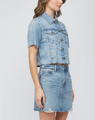 Hidden Short Sleeve Crop Jacket. This denim jacket features a cropped fit and short sleeve design with button closures and front patch pockets, wear it open as a layering piece or closed on its own.