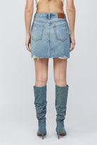 Hidden Peyton Mini Skirt Medium Blue. This classic denim mini is a closet must have for the spring and summer, in a medium blue wash featuring distressed details for a worn in timeless look.
