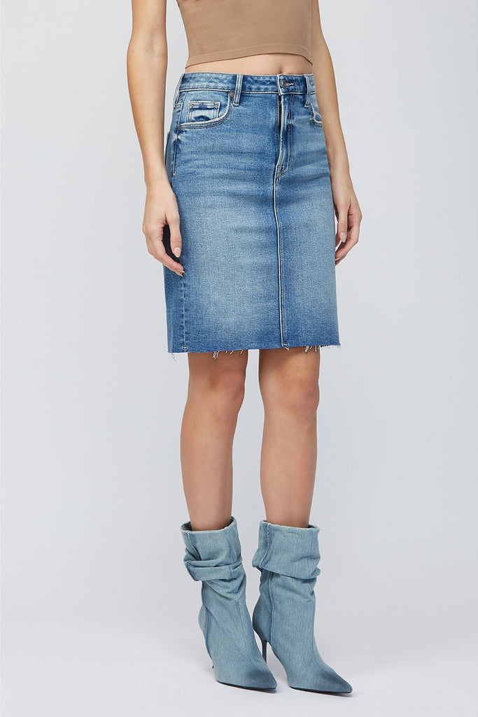 Hidden Midi Pencil Skirt Denim. This pencil skirt features a high waist with a midi length and medium blue wash with raw edge, the perfect piece to add to your spring rotation.