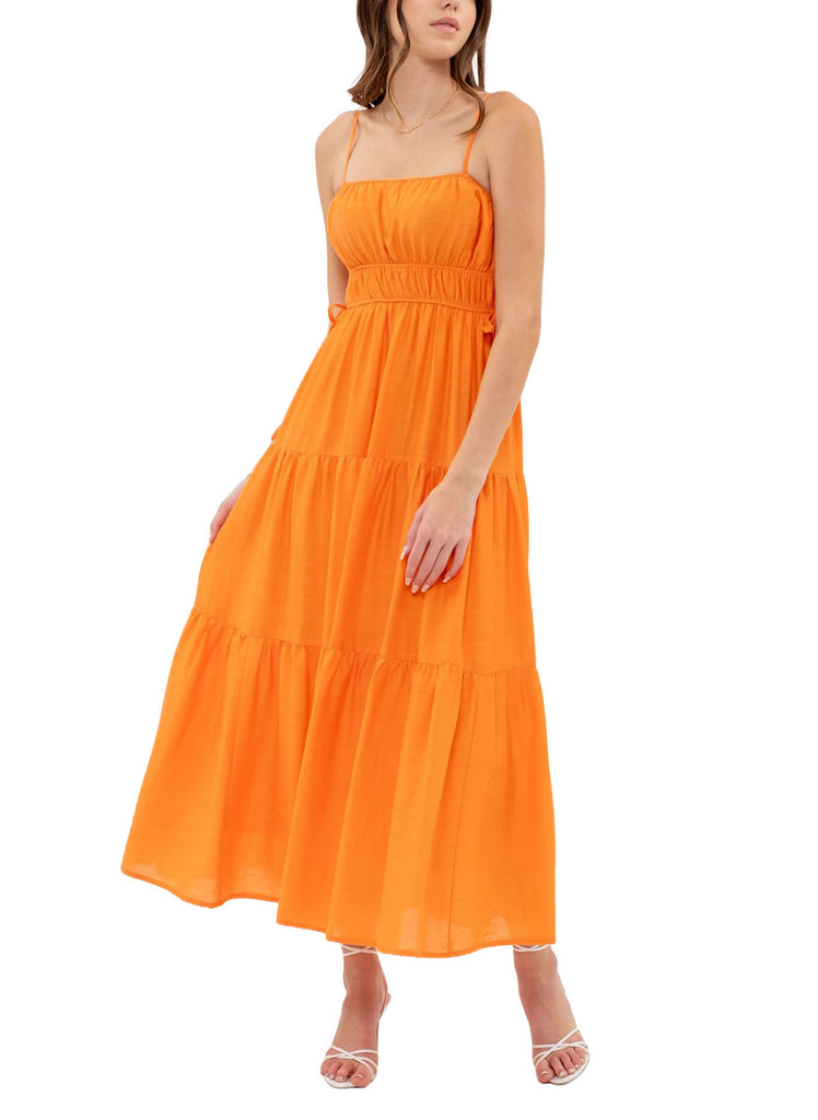 Wynter Tiered Maxi Dress Cantaloupe. This tiered maxi dress features a straight neckline and adjustable spaghetti straps, the perfect bright piece to add to your spring wardrobe for a pop of color.