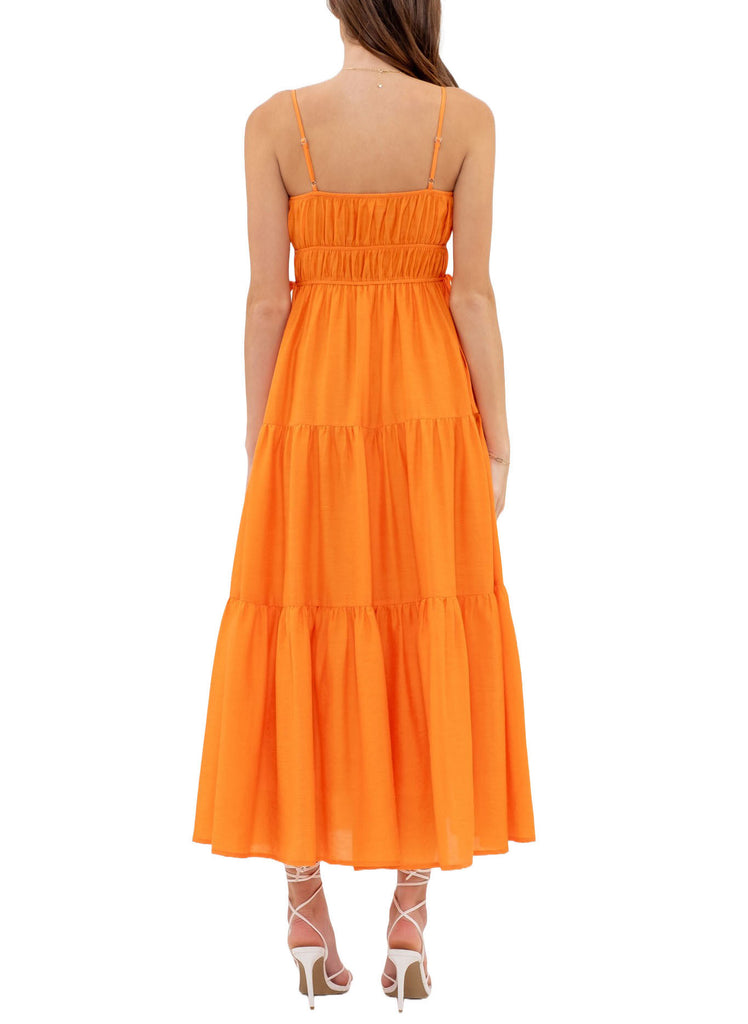 Wynter Tiered Maxi Dress Cantaloupe. This tiered maxi dress features a straight neckline and adjustable spaghetti straps, the perfect bright piece to add to your spring wardrobe for a pop of color.