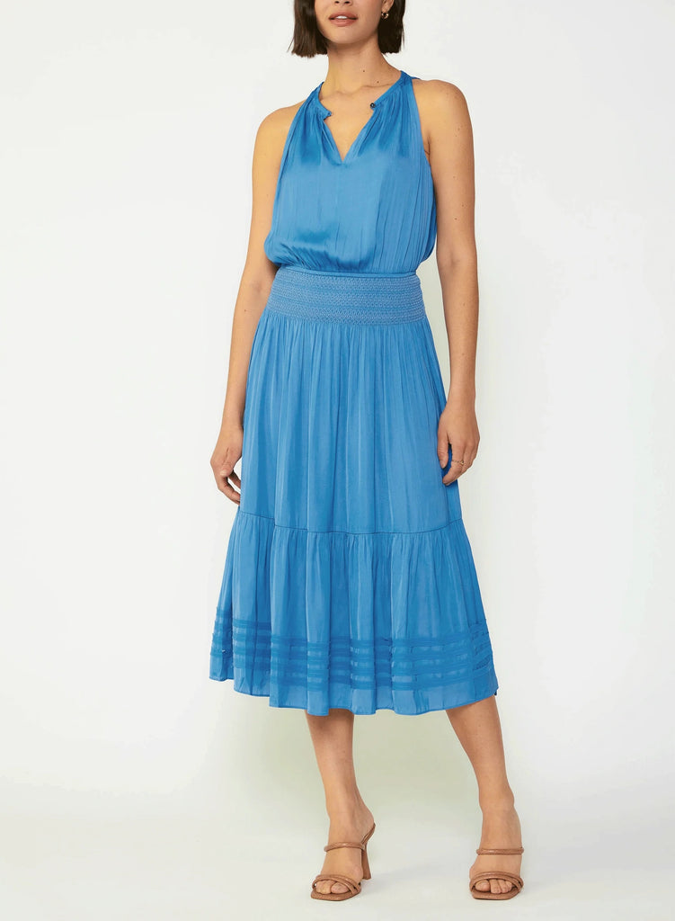 Current Air Halter Key Hole Midi Dress Faded Blue. An effortless midi dress that's simple yet stunning. The sleeveless halter style is beautifully gathered at the bodice and smocked at the waist, complete with tonal embroidery. The skirt flows to a shin-skimming tiered hem encircled by tonal chiffon bias tape.