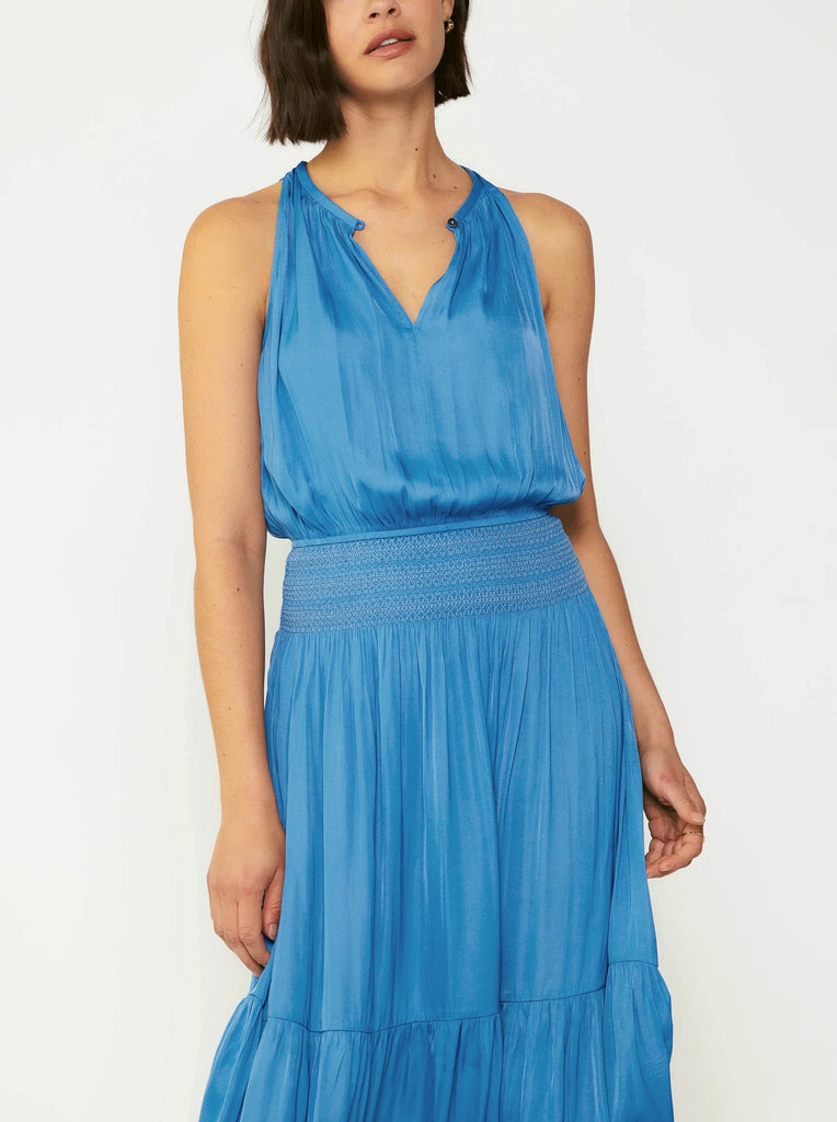 Current Air Halter Key Hole Midi Dress Faded Blue. An effortless midi dress that's simple yet stunning. The sleeveless halter style is beautifully gathered at the bodice and smocked at the waist, complete with tonal embroidery. The skirt flows to a shin-skimming tiered hem encircled by tonal chiffon bias tape.