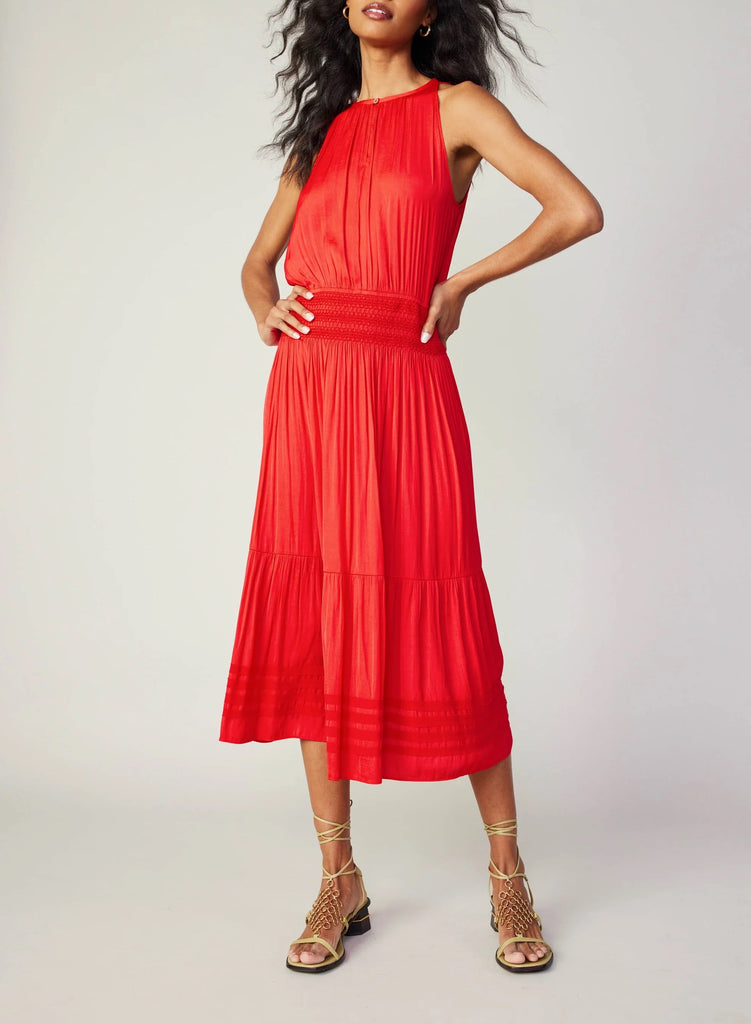 Current Air Halter Key Hole Midi Dress Bright Red. An effortless midi dress that's simple yet stunning. The sleeveless halter style is beautifully gathered at the bodice and smocked at the waist, complete with tonal embroidery. The skirt flows to a shin-skimming tiered hem encircled by tonal chiffon bias tape.