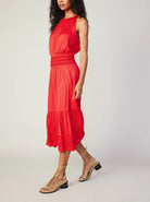 Current Air Halter Key Hole Midi Dress Bright Red. An effortless midi dress that's simple yet stunning. The sleeveless halter style is beautifully gathered at the bodice and smocked at the waist, complete with tonal embroidery. The skirt flows to a shin-skimming tiered hem encircled by tonal chiffon bias tape.