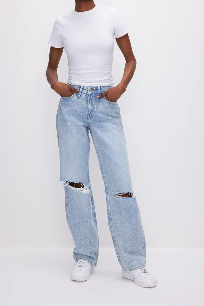 Good American 90s Jeans Blue. These iconic ‘90s inspired relaxed jeans feature a loose straight leg design, distressed knees and a rigid denim for the perfect vintage look.
