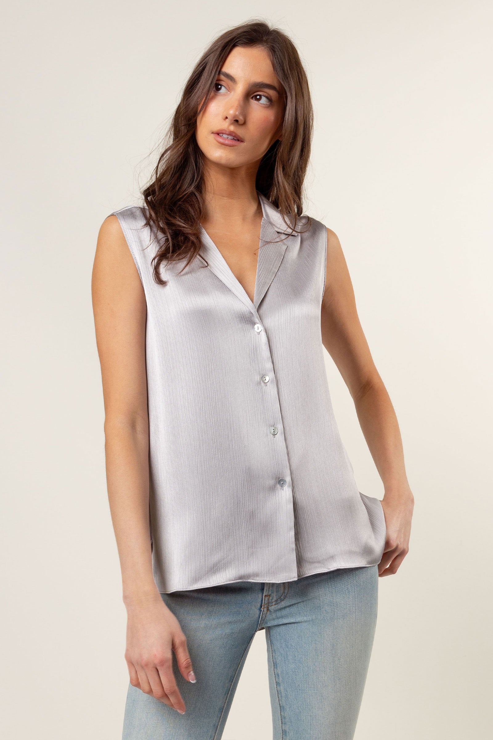 grey sleeveless button up collared blouse
