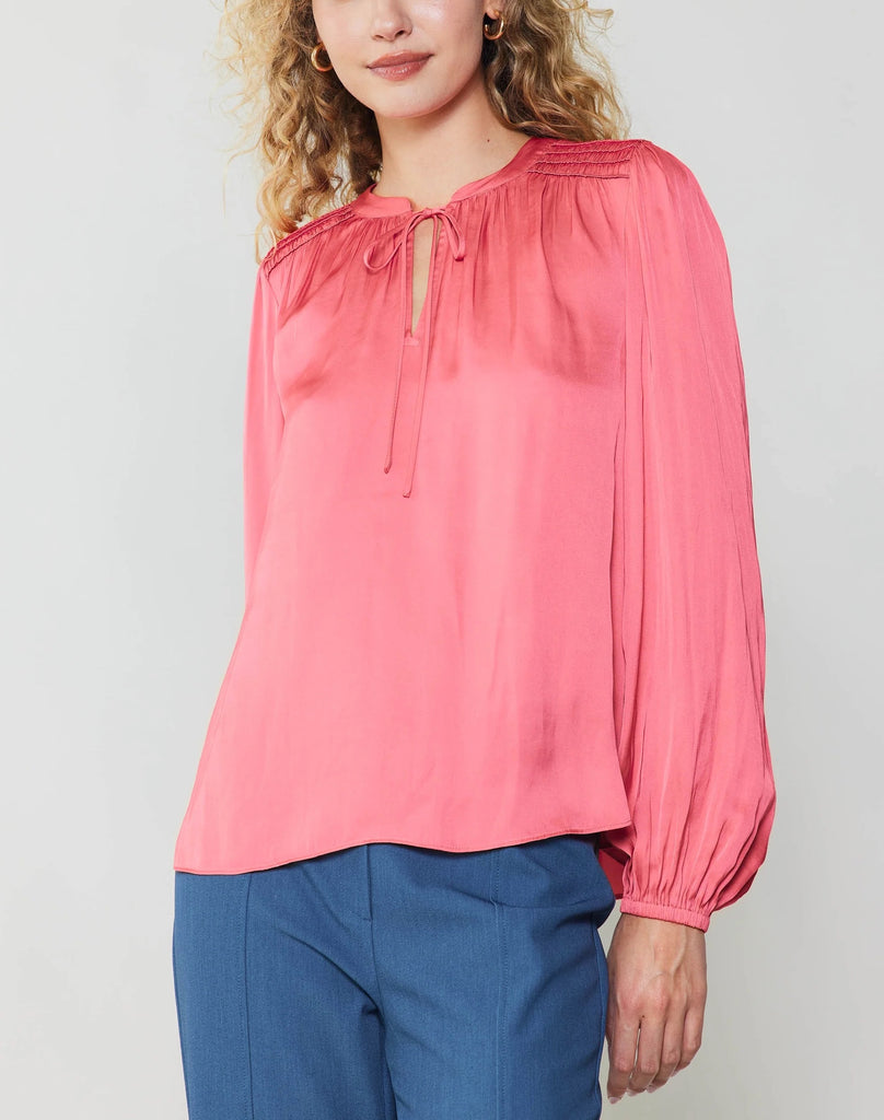 Current Air Tie Smock Blouse Brink Pink. A lustrous split-neck blouse brings polished ease to any outfit. This popover top has a fluid fit that's framed by puffed sleeves and features a delicate shirred yoke. That little tie detail at the neckline delivers the sweetest finish.