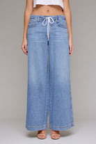 Wide-leg pull-on denim jeans with a drawstring waistband, relaxed fit, and full-length silhouette.