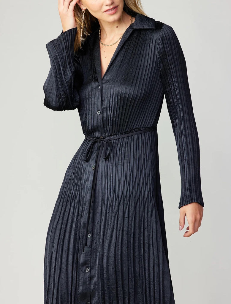 Current Air Pleated Midi Dress Black. This button-up shirt dress has a crinkled texture, soft pleats, and a slender self-tie belt to define the shape. Layer a cardigan or jacket on top to take it into the cooler seasons.