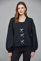 bow detail sweater, embellished knit top, women’s statement sweater, feminine knitwear, chic boutique sweater, V-neck sweater women, dressy casual sweater, holiday knit top, fashion-forward sweater, trendy women’s knit