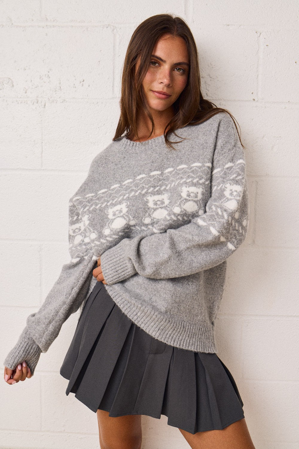 Women’s relaxed crewneck sweater with a skull motif, long sleeves, and ribbed trim.