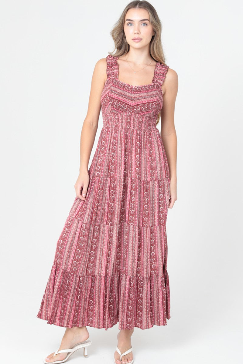 Printed tiered maxi dress with fitted bodice and flowy skirt on model