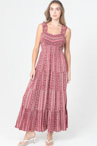 Printed tiered maxi dress with fitted bodice and flowy skirt on model