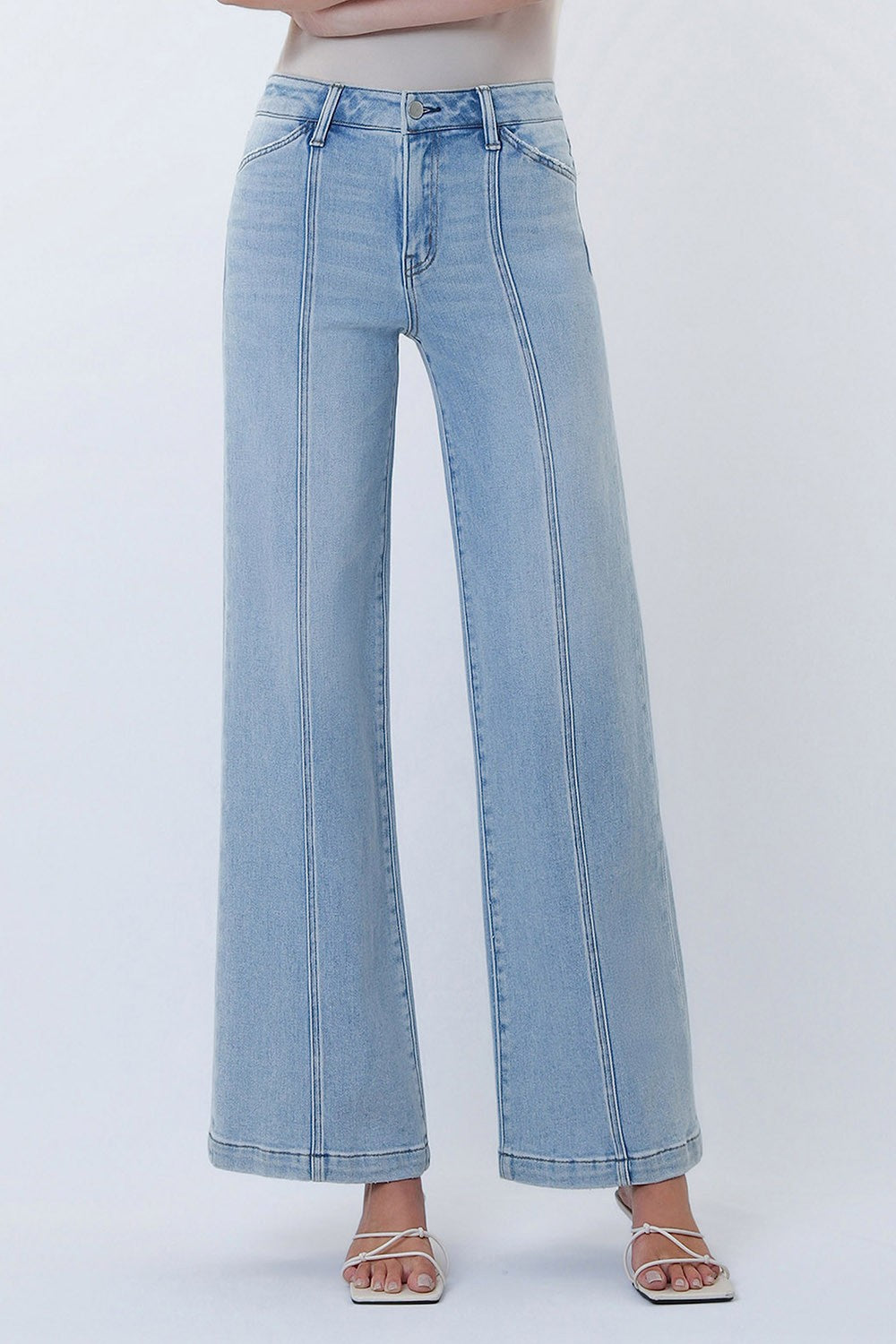 High-rise wide leg jeans with front seam detailing and a structured fit styled with sandals