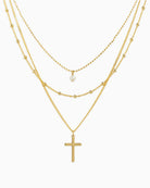 layered cross necklace, gold layered necklace, cross pendant necklace, dainty gold necklace set, pearl accent necklace, women’s layered jewelry, delicate gold necklace, boutique jewelry necklace, minimalist cross necklace, everyday gold jewelry