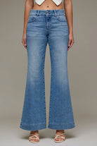 High-rise wide leg pants with full length silhouette styled with heels