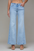 Model wearing light wash high-rise cropped wide-leg jeans with a relaxed fit.